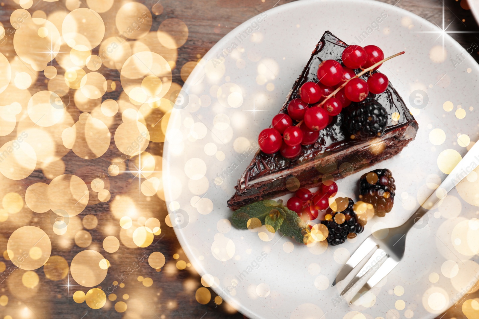 Image of Yummy chocolate cake with berries on wooden table, top view. Tasty dessert for Christmas dinner