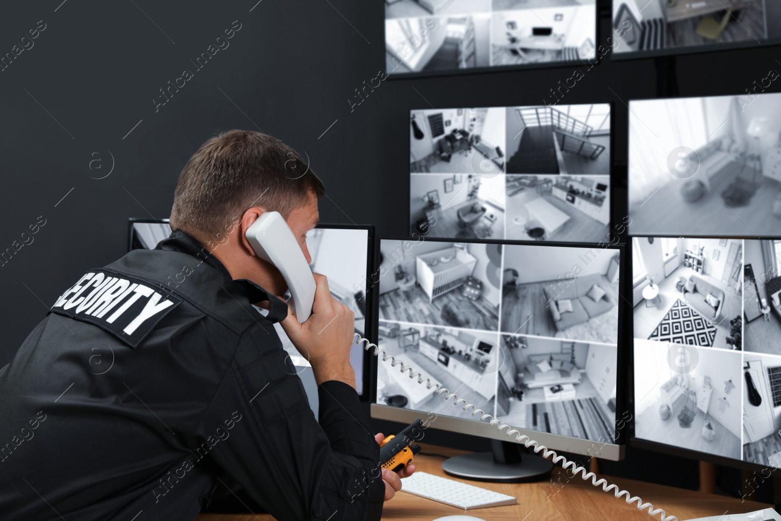 Photo of Security guard talking on telephone at workplace