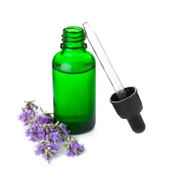 Bottle of essential oil and lavender flowers isolated on white