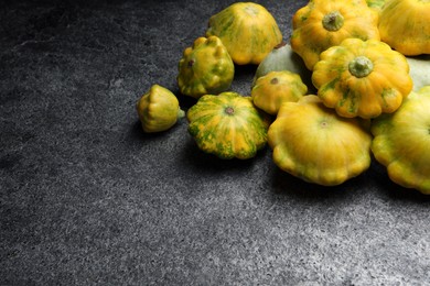 Fresh ripe pattypan squashes on grey table. Space for text