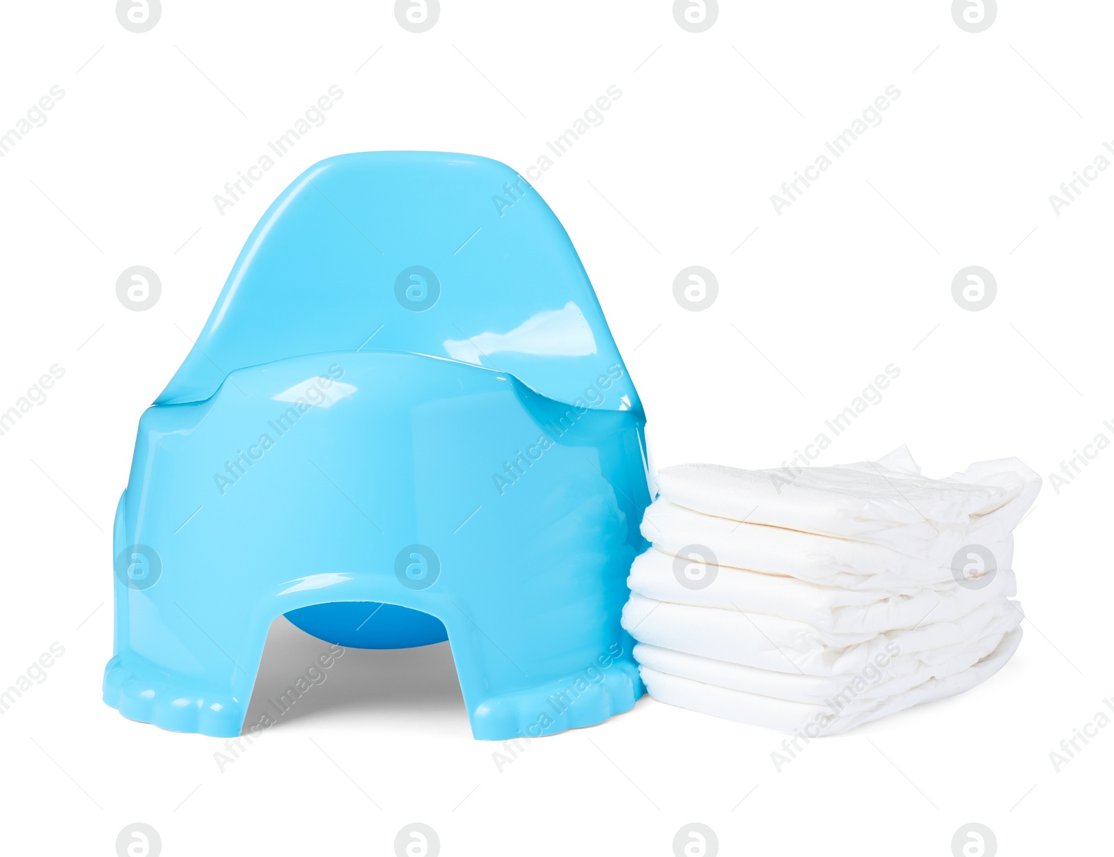 Photo of Light blue baby potty and stack of diapers isolated on white. Toilet training