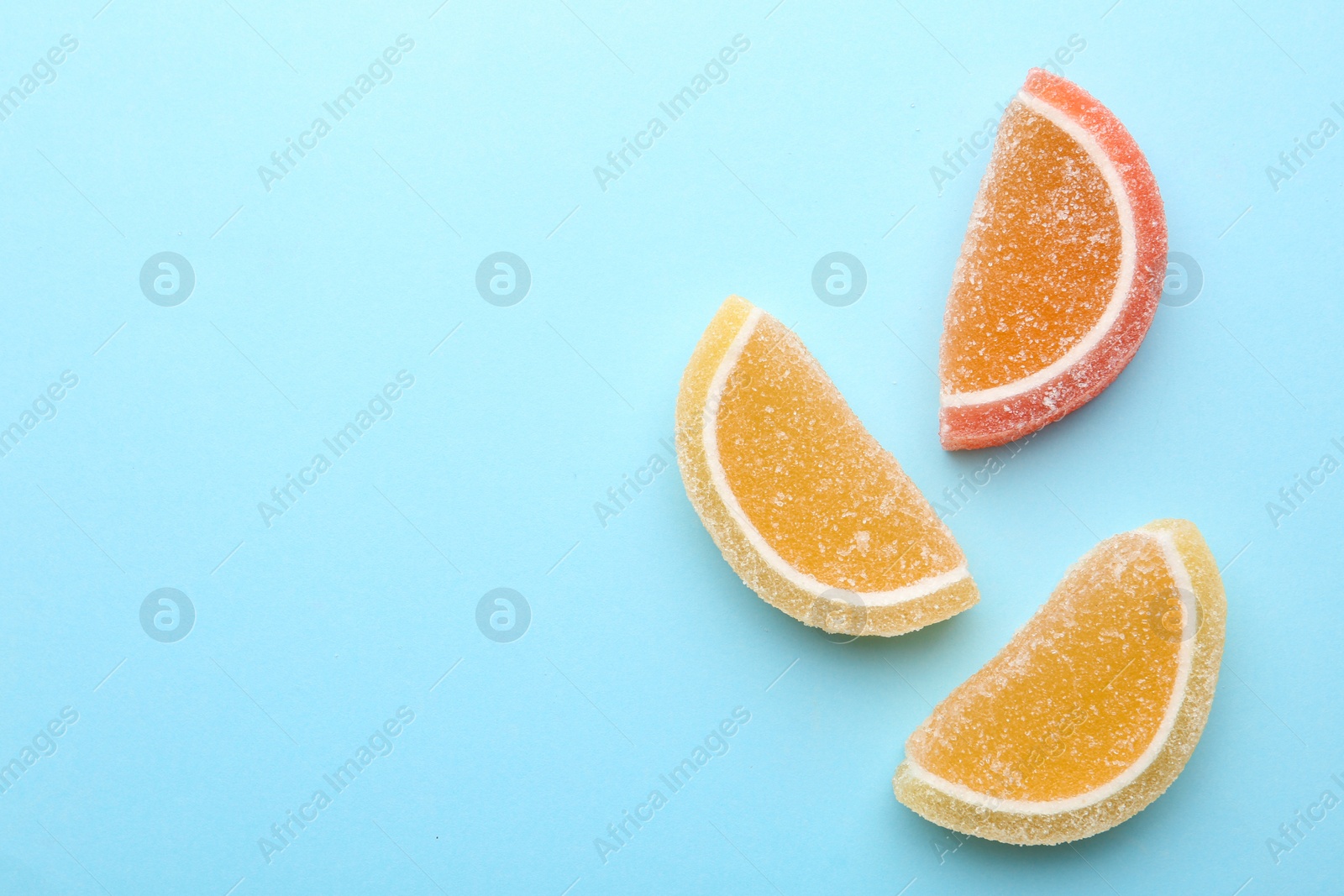 Photo of Tasty jelly candies on color background, top view with space for text