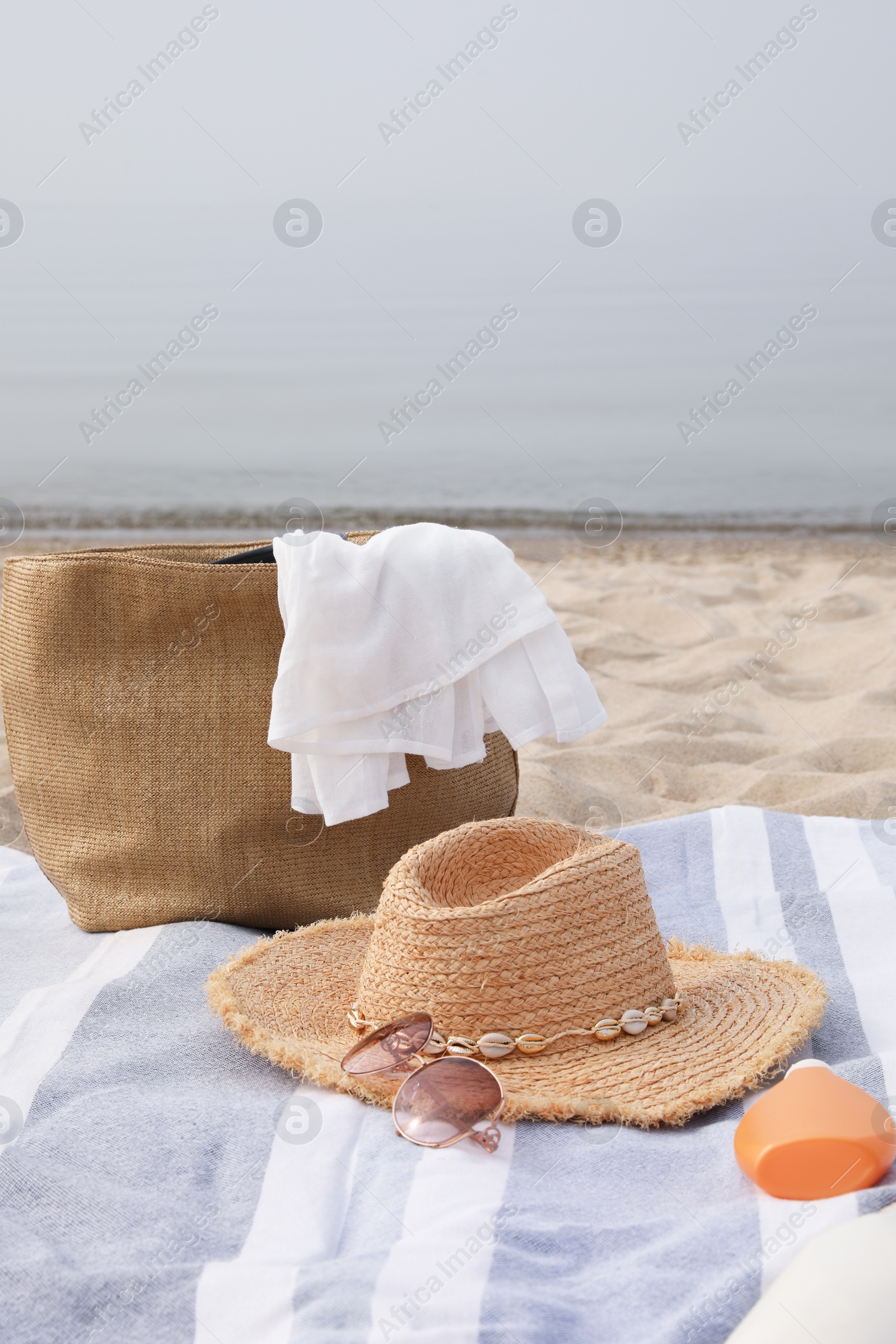 Photo of Bag and other beach items on sandy seashore