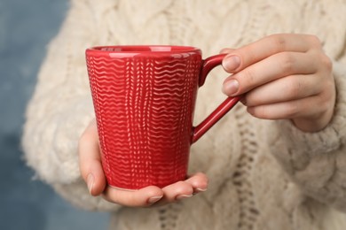 Photo of Woman holding mug of hot drink, closeup. Coffee Break
