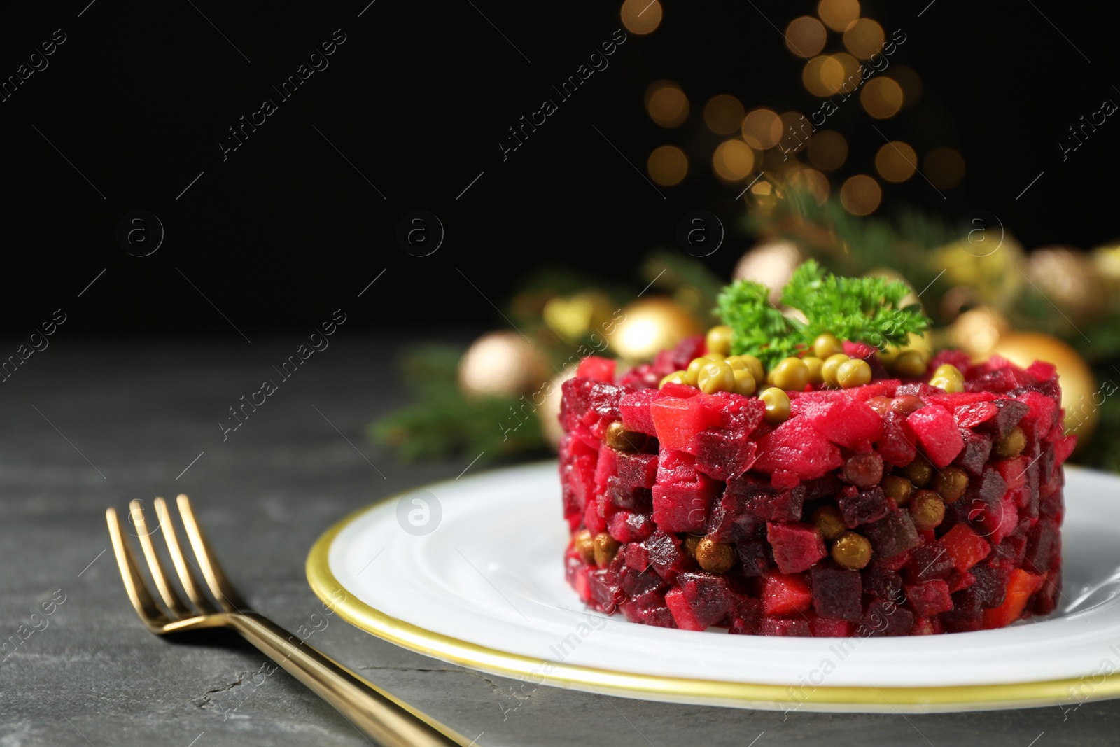 Photo of Traditional Russian salad vinaigrette served on grey table, closeup. Space for text