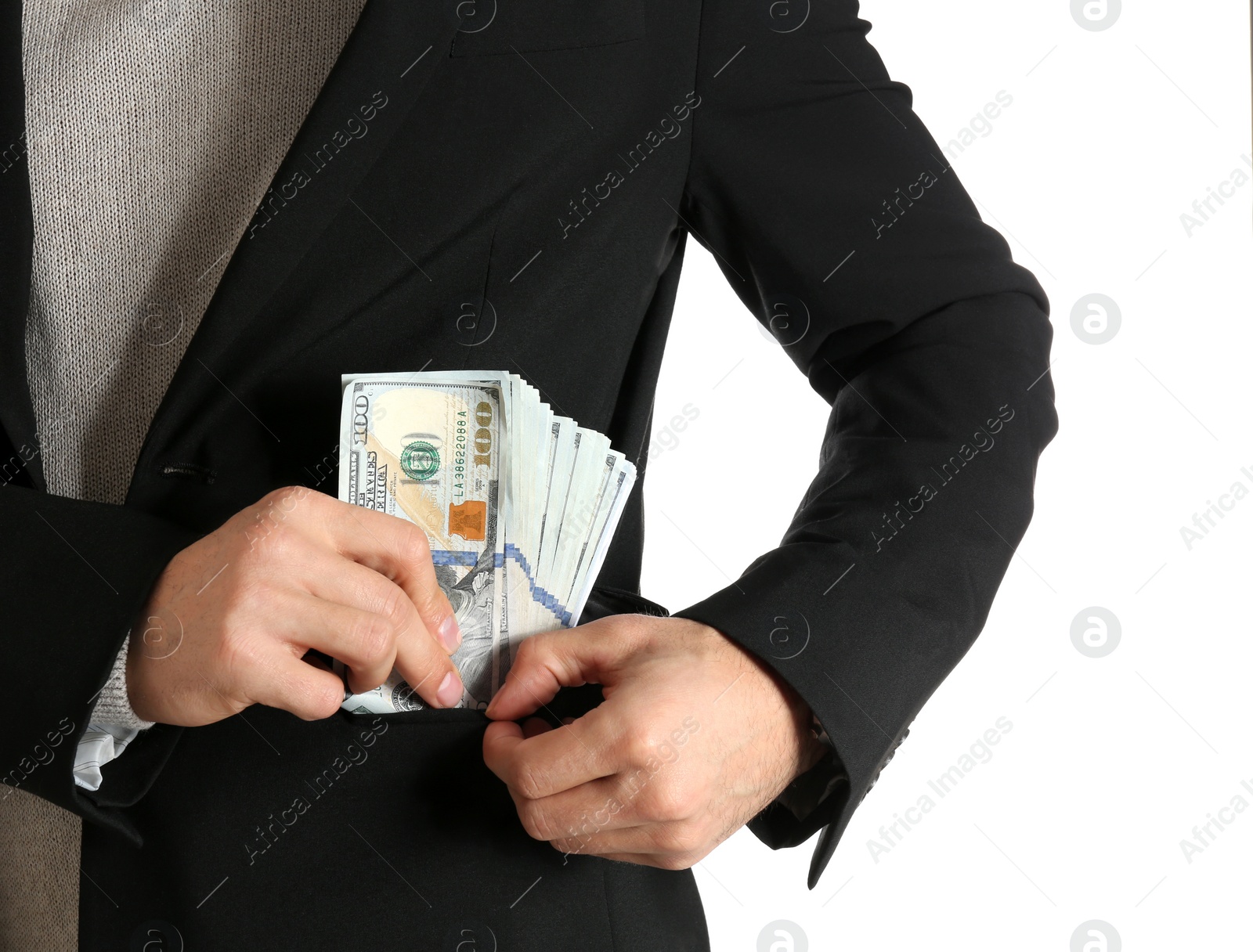 Photo of Man putting bribe money into pocket on white background, closeup