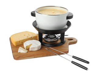 Photo of Fondue with tasty melted cheese, forks and pieces isolated on white