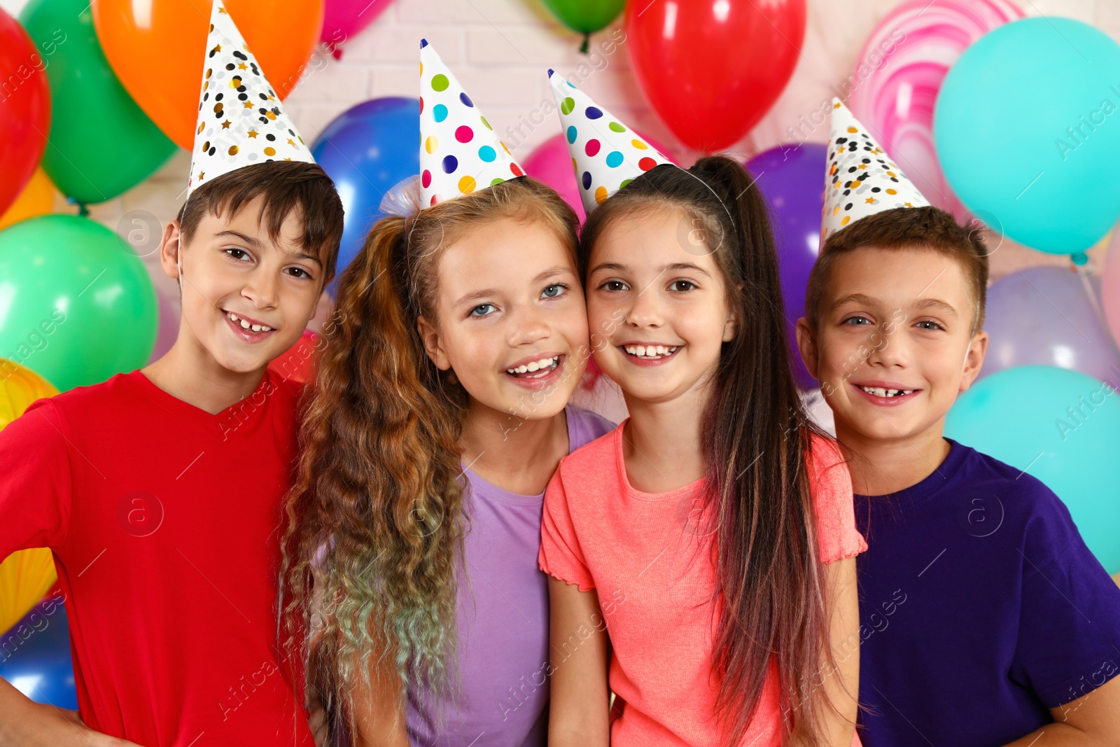 Photo of Happy children near bright balloons at birthday party indoors