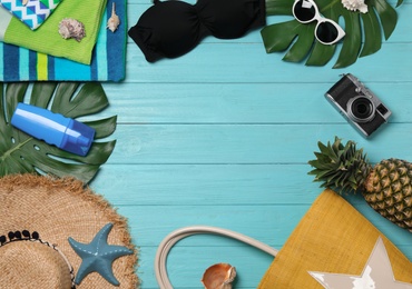 Photo of Flat lay composition with beach accessories on wooden background. Space for text