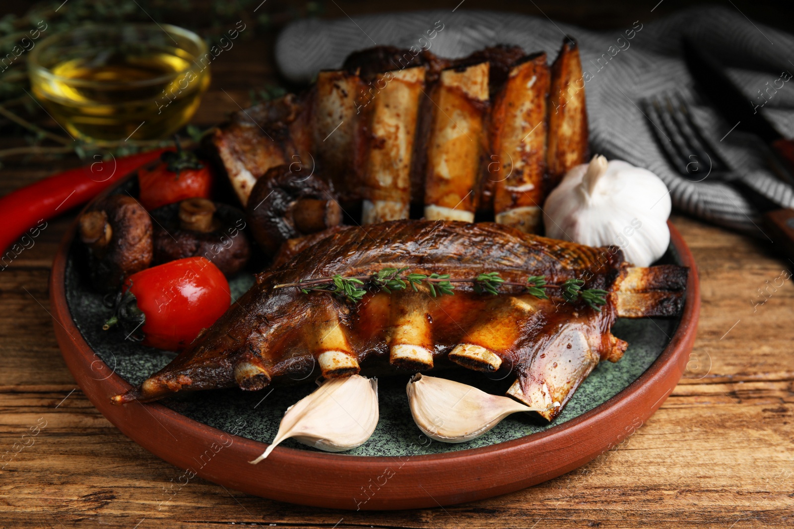 Photo of Delicious roasted ribs served on wooden table