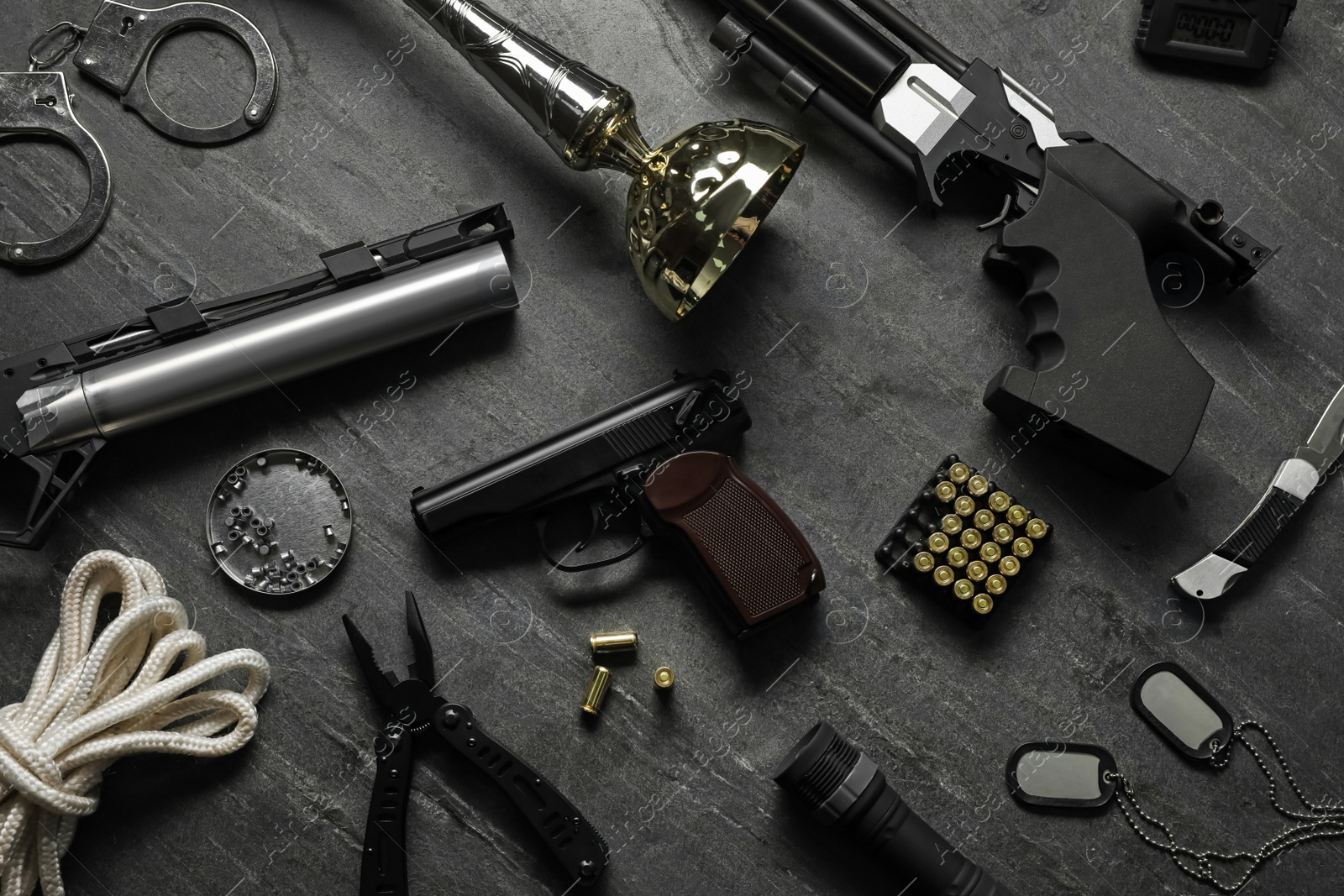 Photo of Flat lay composition with different guns on dark table