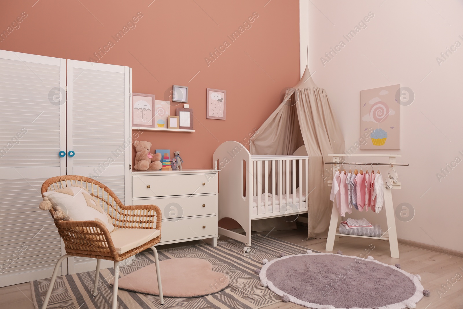 Photo of Baby room interior with stylish furniture and comfortable crib