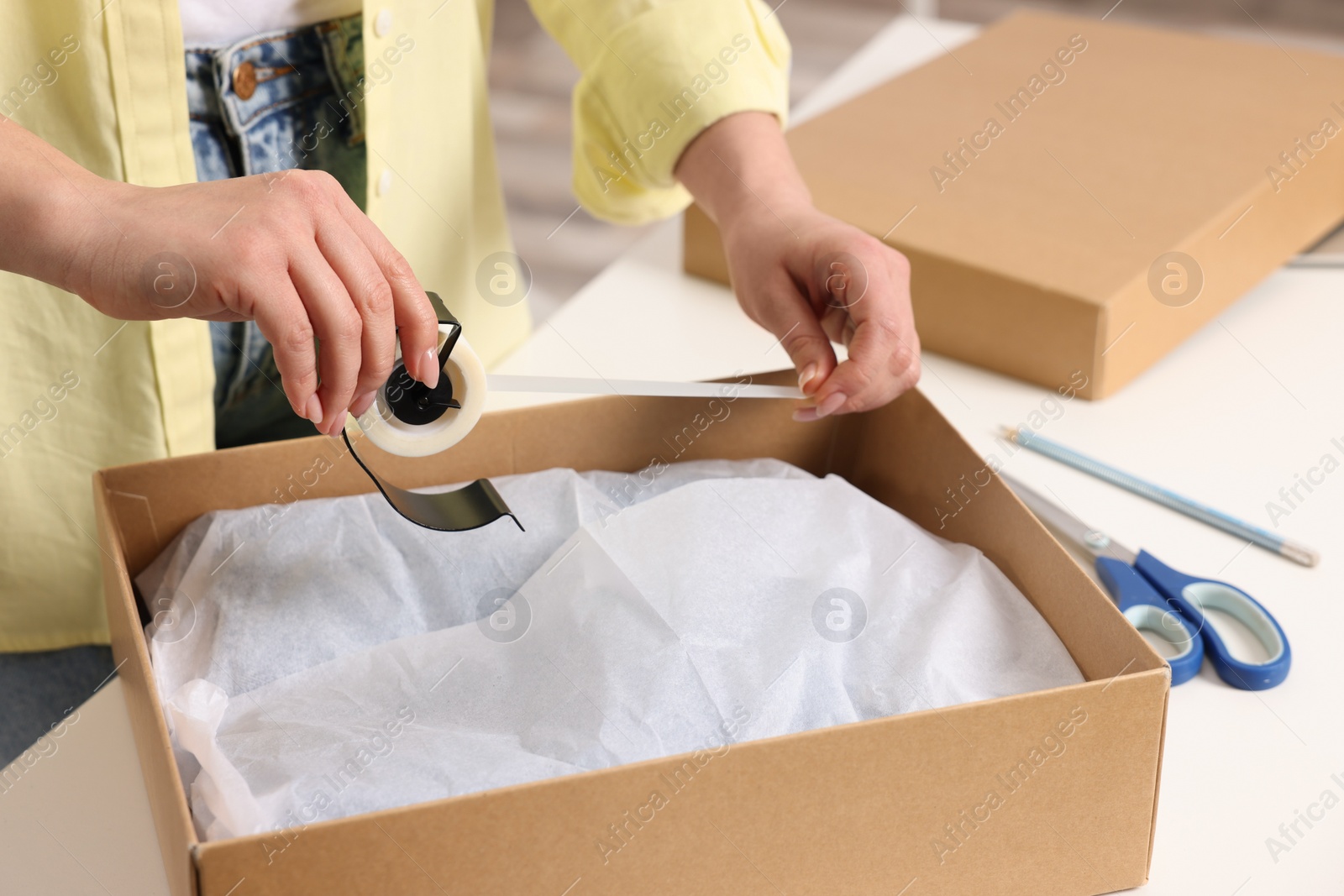 Photo of Seller preparing package at workplace, closeup view