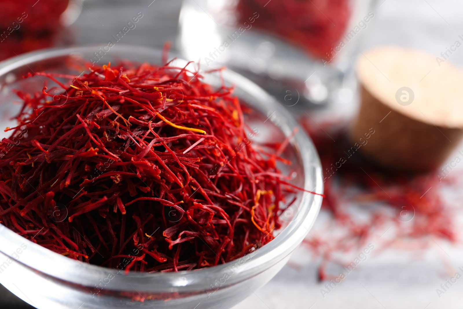 Photo of Dried saffron in glass bowl, closeup view