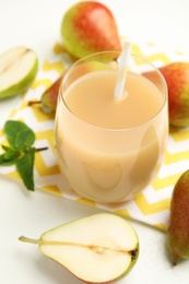 Tasty pear juice and fruits on white table, closeup