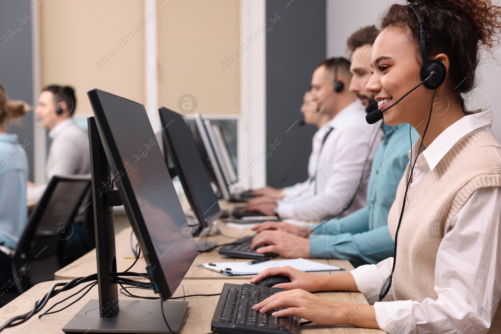 Photo of Call center operators working in modern office