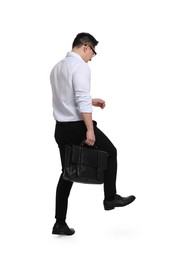 Photo of Businessman with briefcase walking on white background