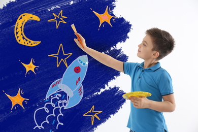 Image of Cute child drawing space on white wall indoors