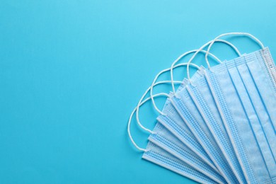 Photo of Protective mask on light blue background, flat lay with space for text. Safety equipment