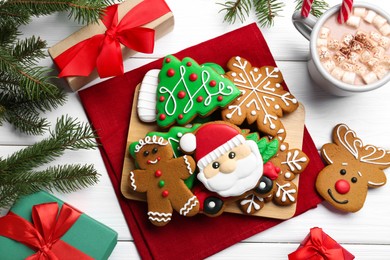 Flat lay composition with tasty homemade Christmas cookies on white wooden table