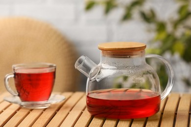 Photo of Delicious hibiscus tea on wooden table indoors