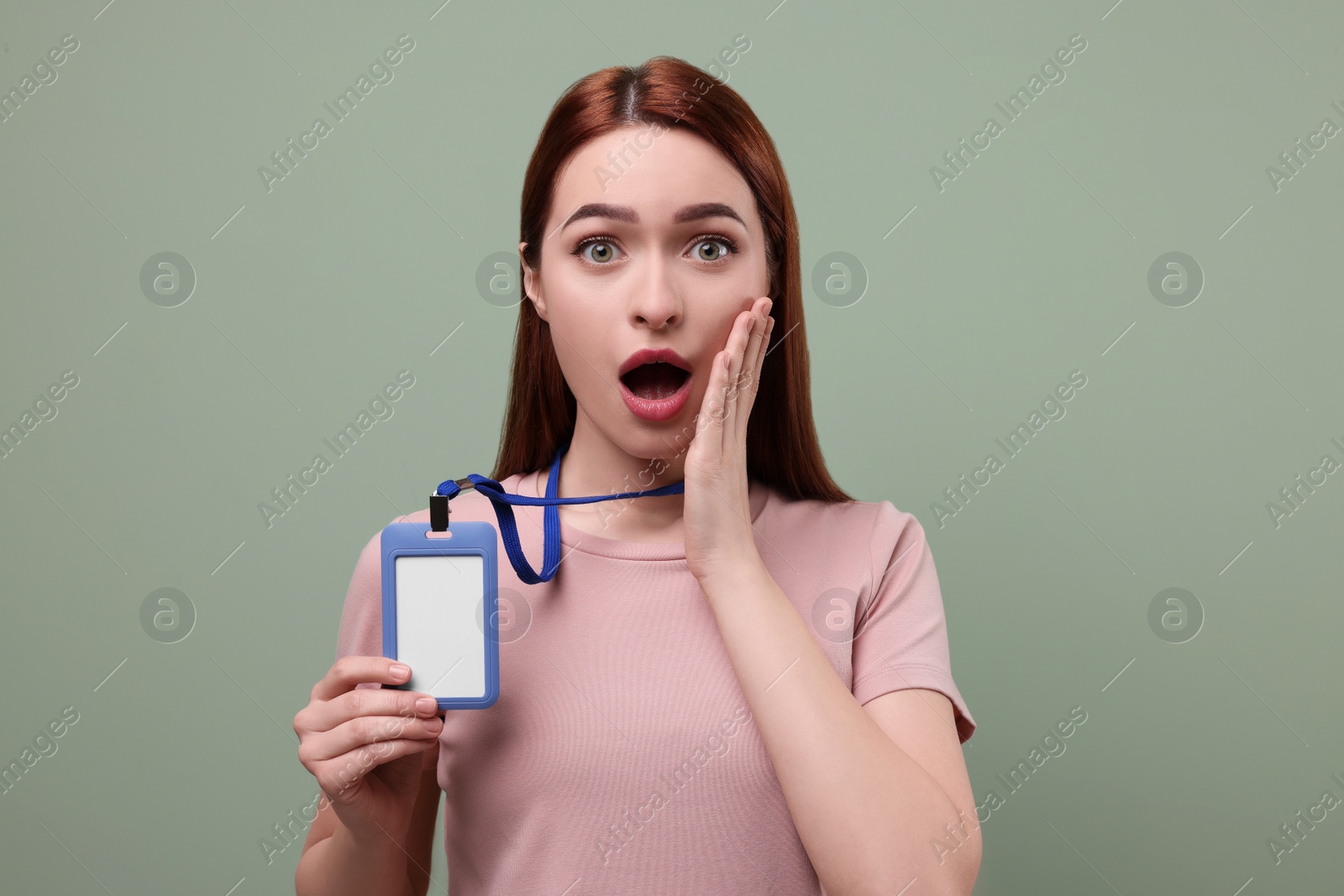 Photo of Shocked woman with vip pass badge on light green background