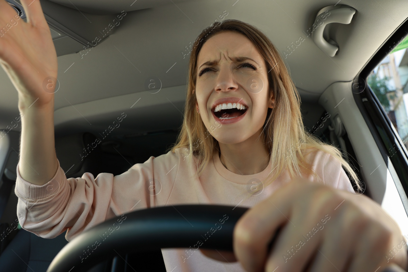 Photo of Stressed angry woman in driver's seat of modern car