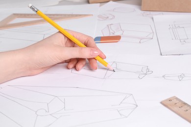 Woman creating packaging design at table, closeup