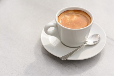 Photo of Ceramic cup of aromatic coffee on table in morning, space for text