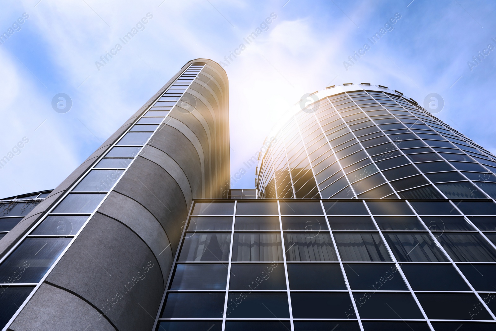 Image of Modern skyscraper with tinted windows against blue sky, low angle view. Building corporation