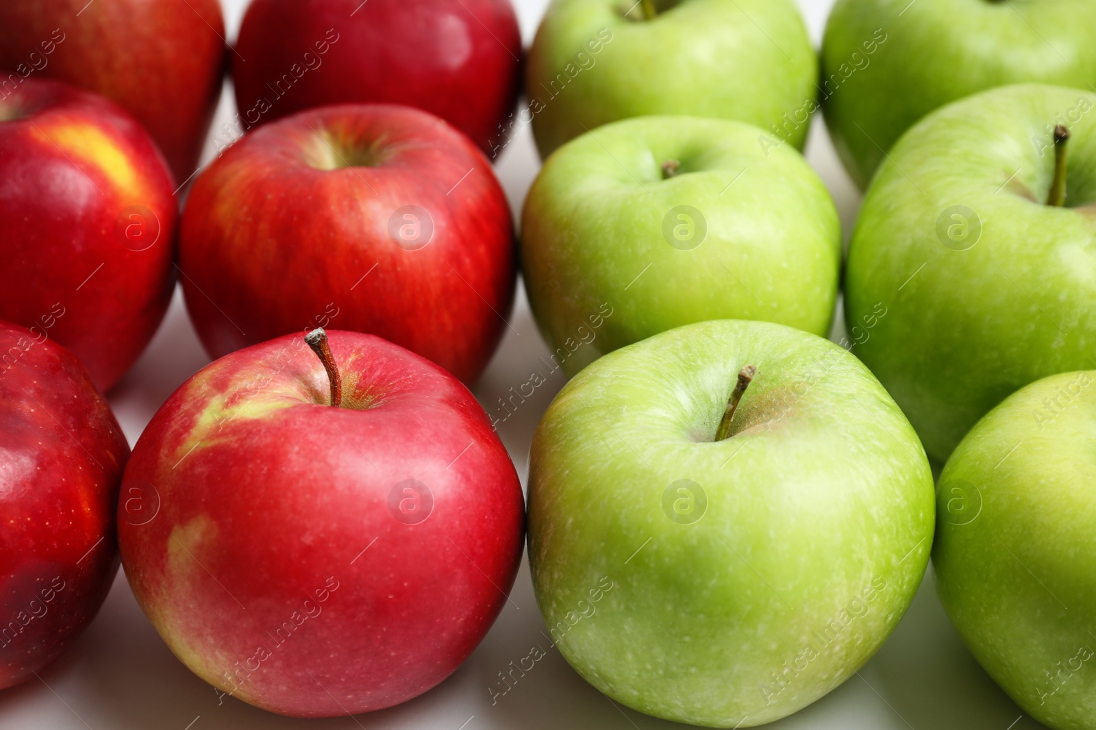 Photo of Fresh green and red apples on white background, closeup