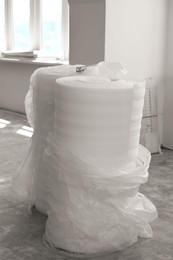 Polyethylene foam rolls on concrete floor indoors