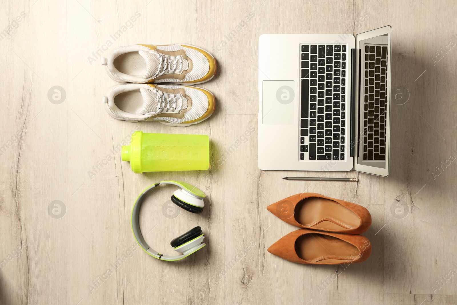 Photo of Flat lay composition with business items and sport accessories on wooden background. Concept of balance between work and life