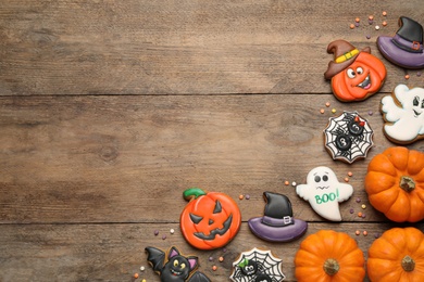 Tasty Halloween cookies on wooden table, flat lay. Space for text