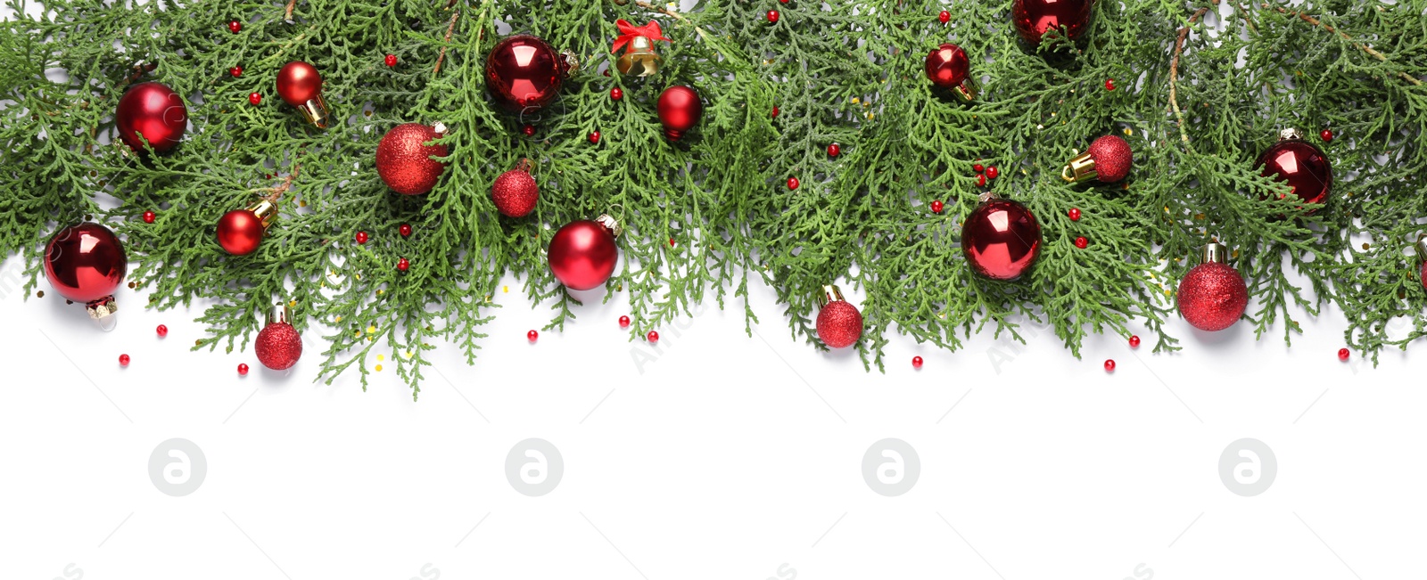 Photo of Thuja branches with Christmas decorations on white background, flat lay