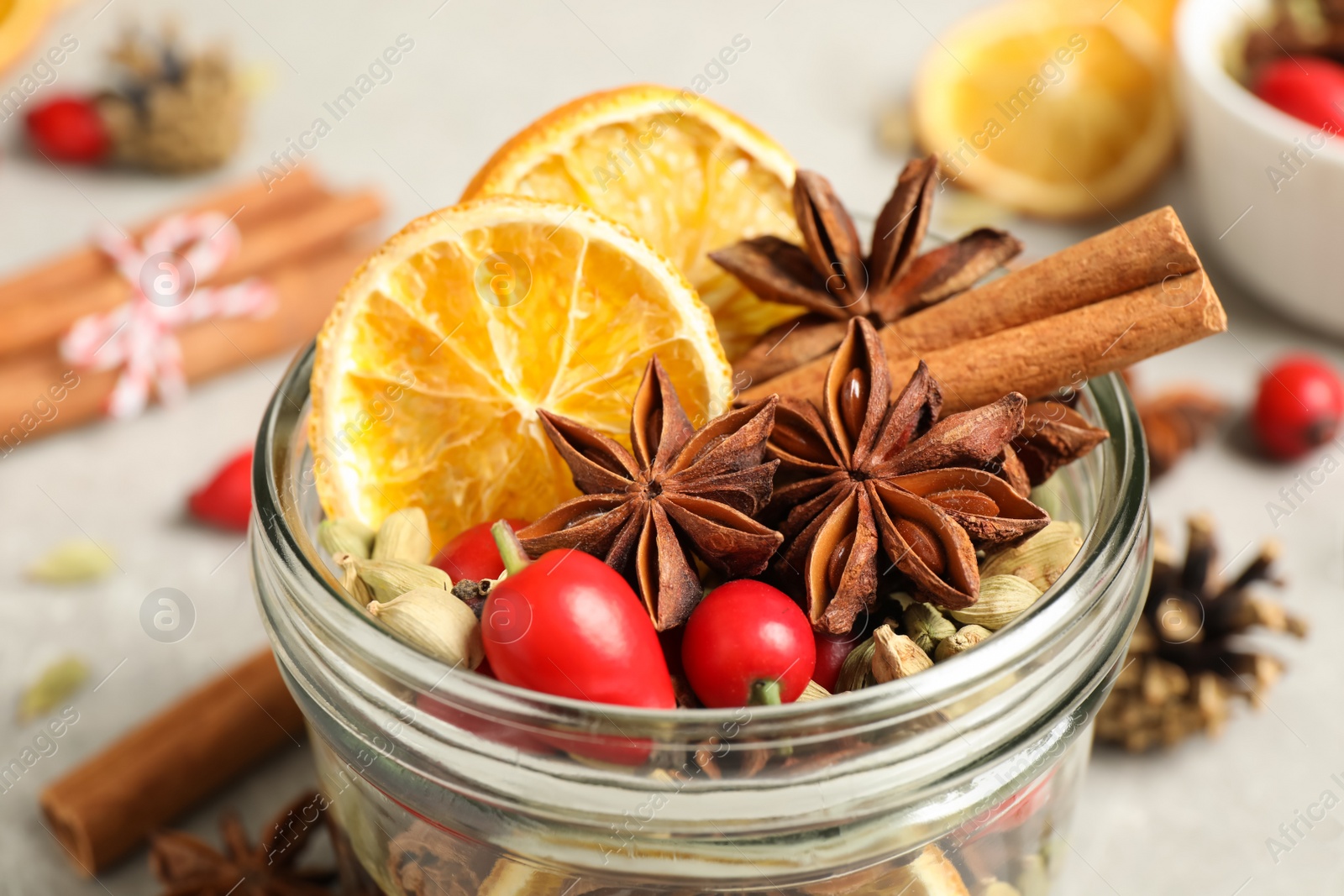 Photo of Aroma potpourri with different spices in jar, closeup view