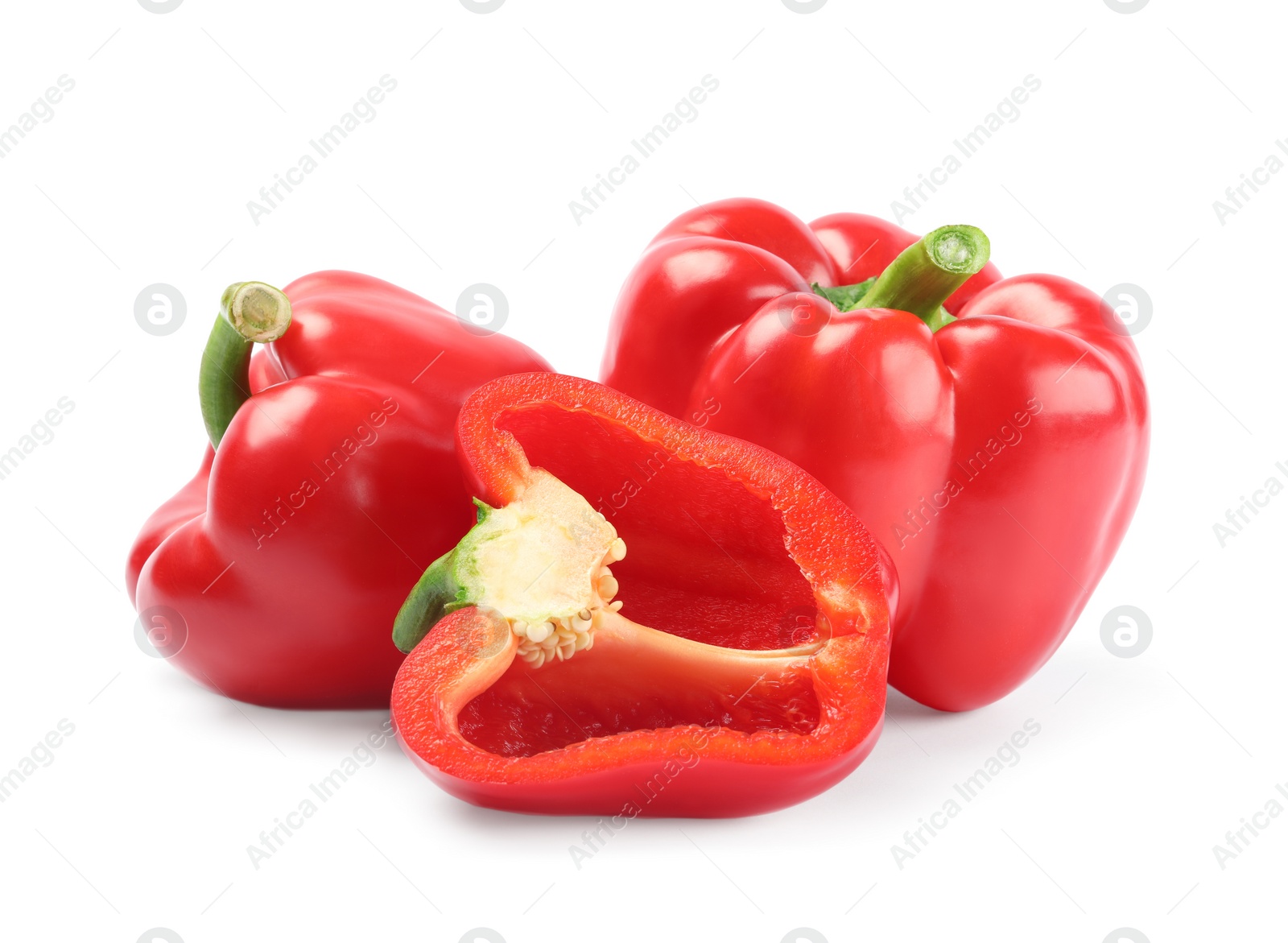 Photo of Whole and cut red bell peppers on white background