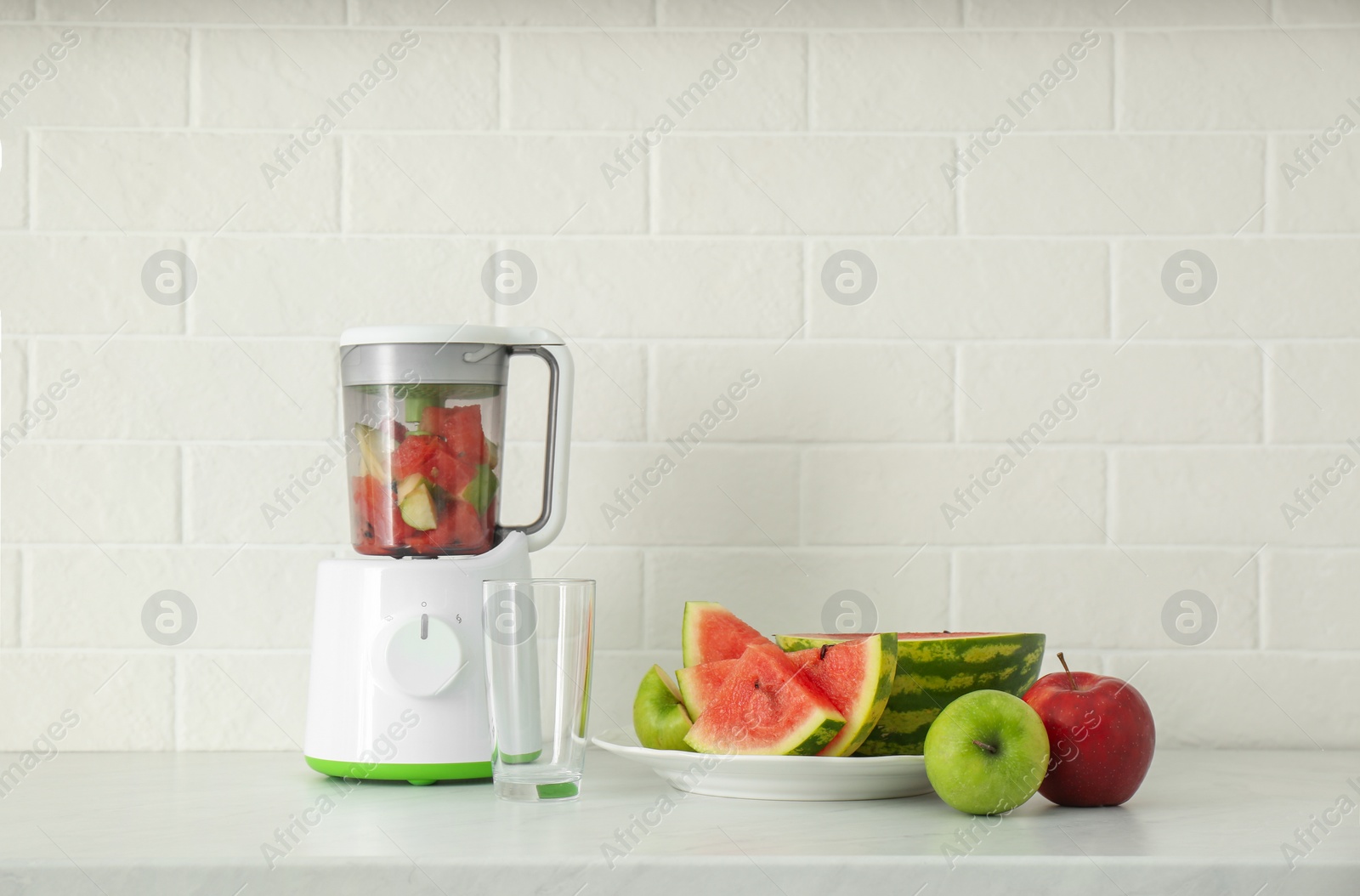 Photo of Blender and smoothie ingredients on counter in kitchen