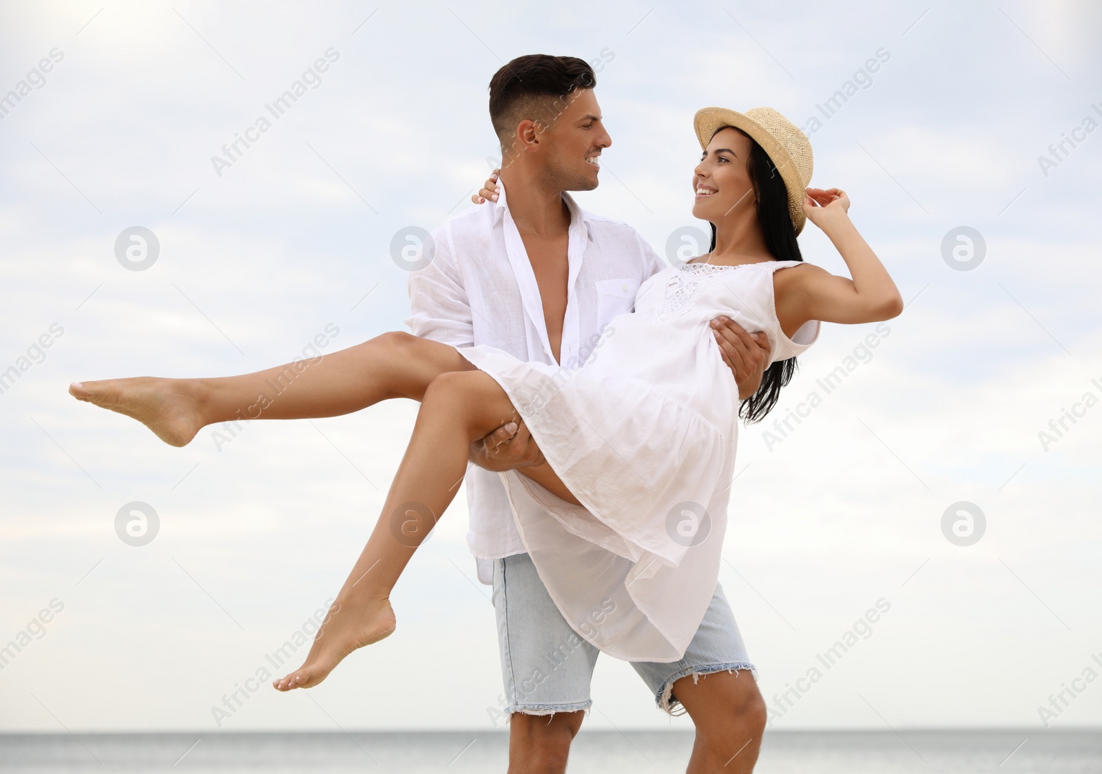 Photo of Lovely couple having fun on beach near sea