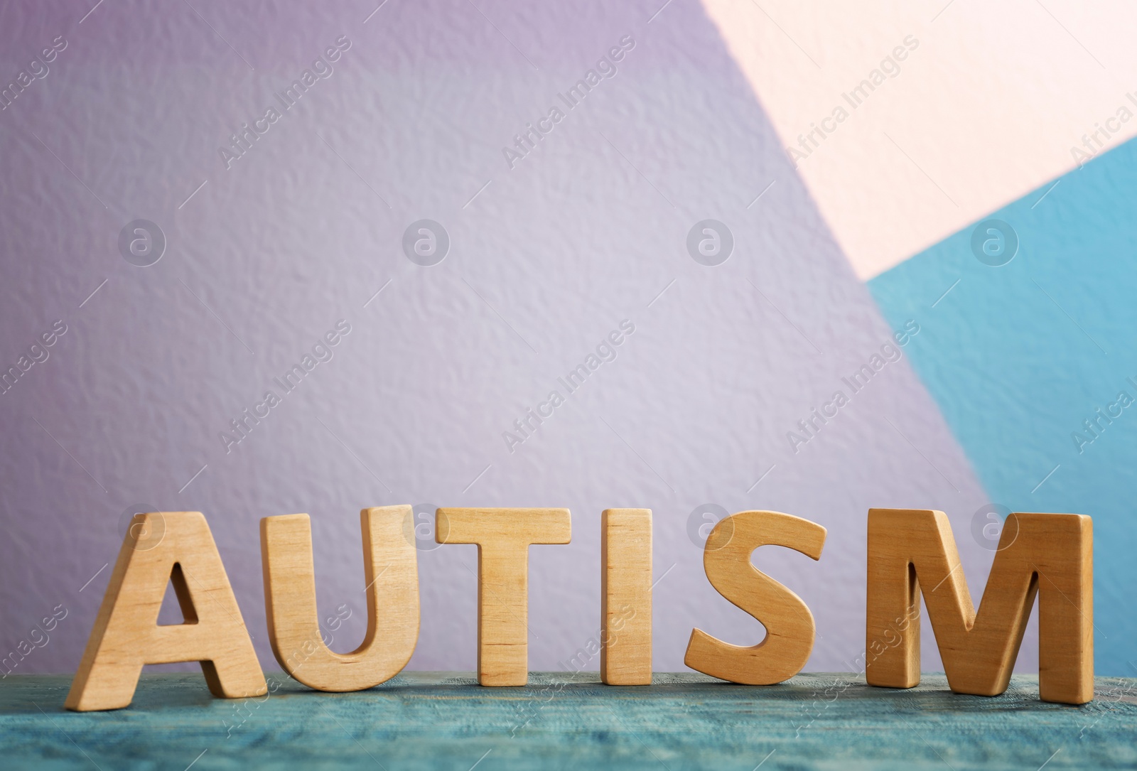 Photo of Word "Autism" composed of wooden letters on table