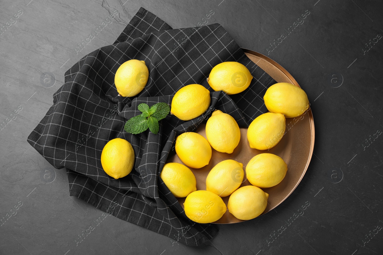 Photo of Flat lay composition with fresh ripe lemons on dark table