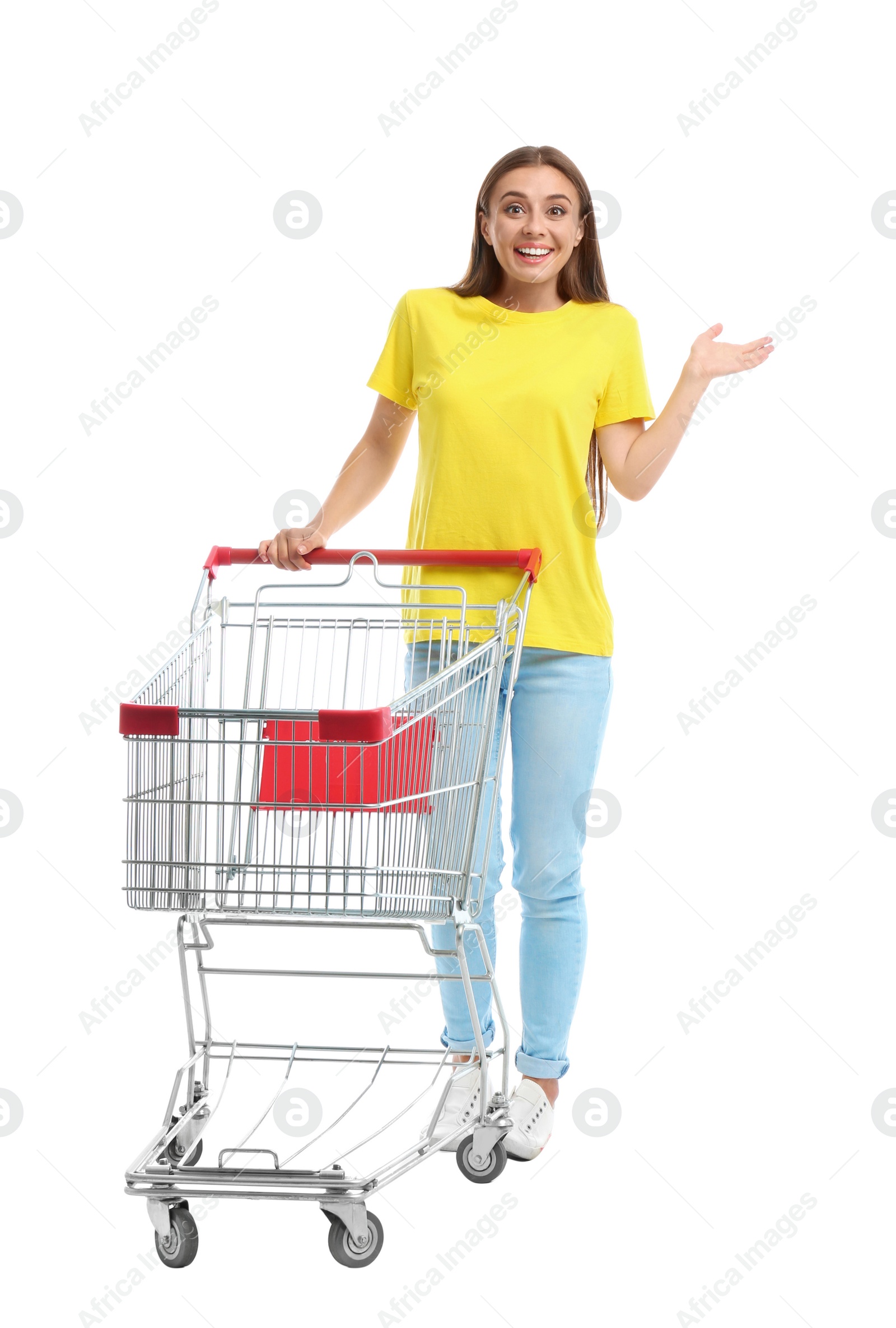 Photo of Young woman with empty shopping cart on white background