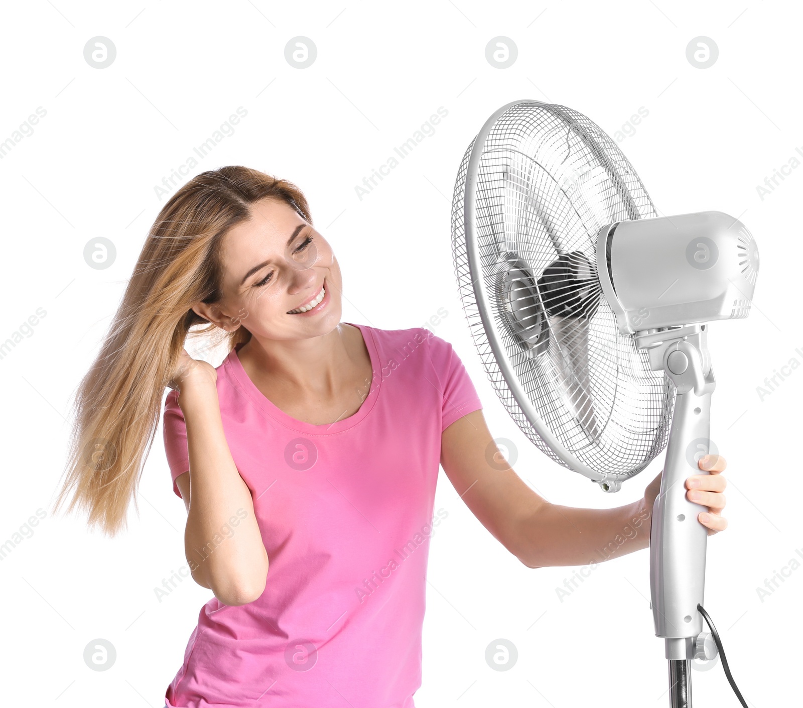 Photo of Woman refreshing from heat in front of fan on white background