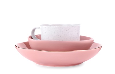 Pink plate, bowl and light cup on white background