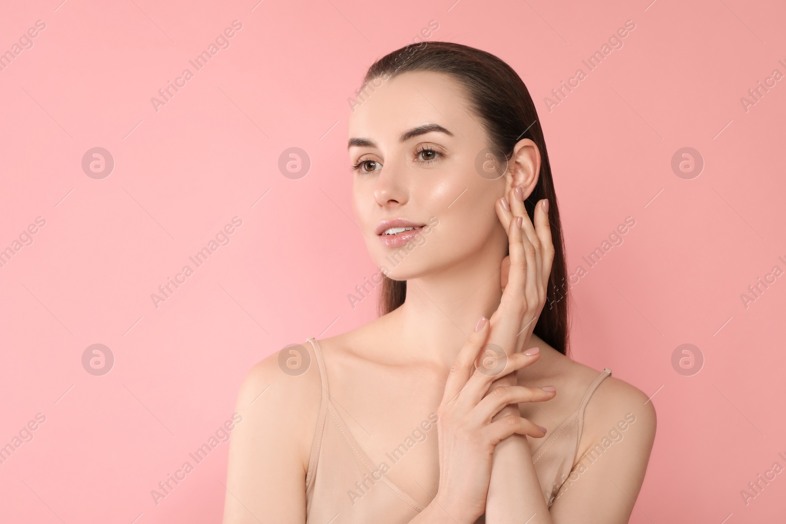 Photo of Portrait of beautiful young woman on pink background