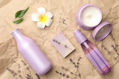 Photo of Flat lay composition with hair care cosmetic products on crumpled paper