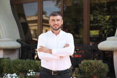 Photo of Portrait of handsome young man on city street