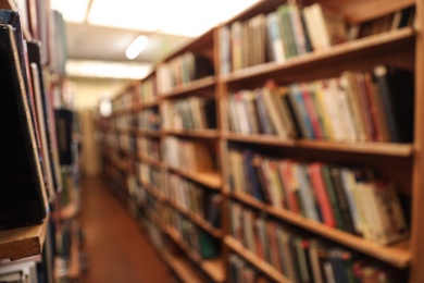 Photo of Blurred view of cabinets with books in library