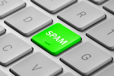 Image of Green button with word Spam on laptop keyboard, closeup