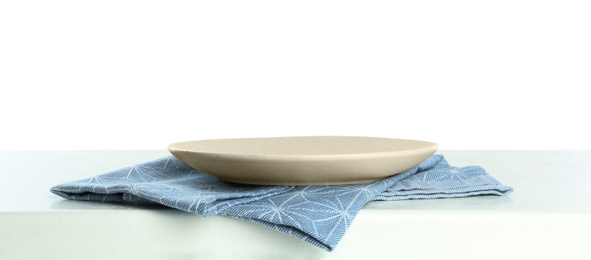 Photo of Empty plate and napkin on light table